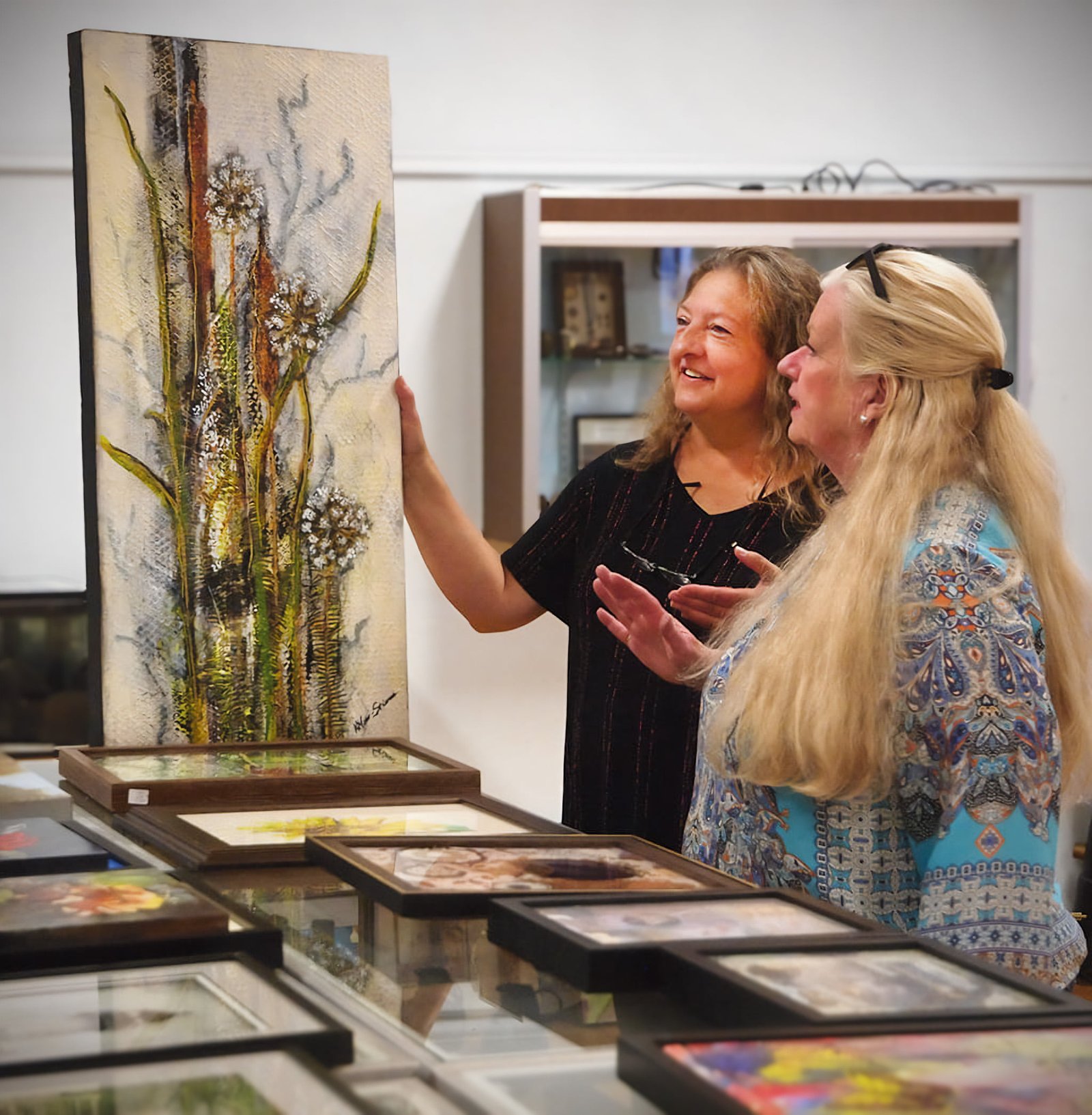 Two Women looking at a piece of artwork