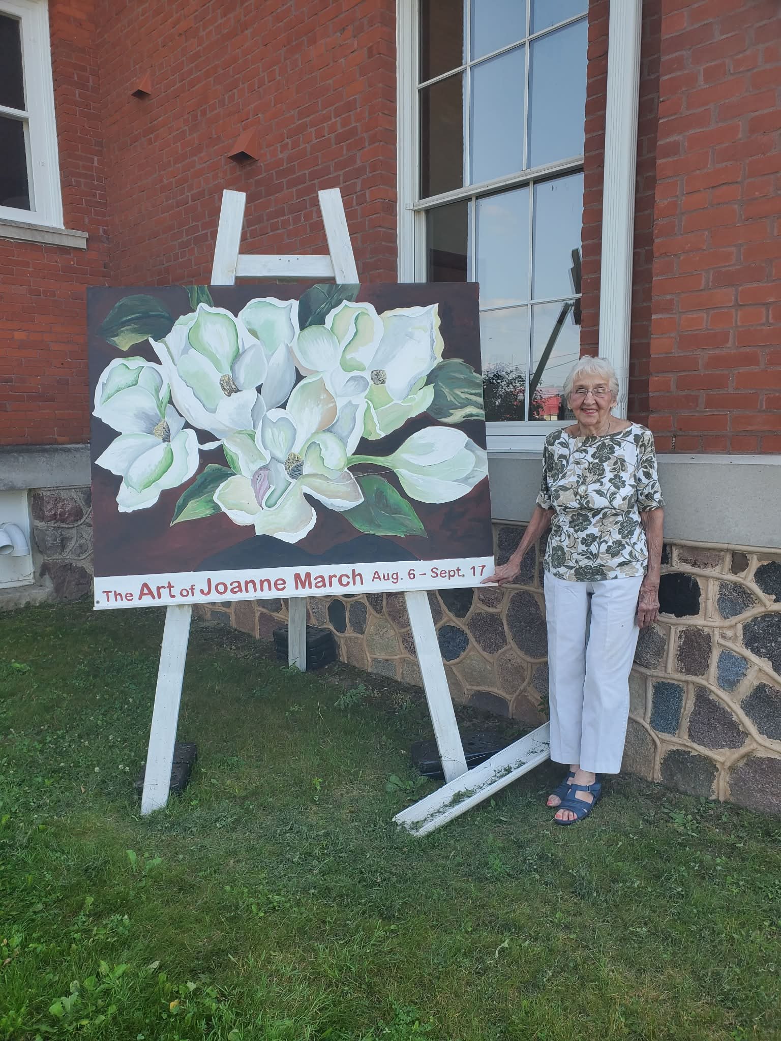 Joanne March posing by large easel